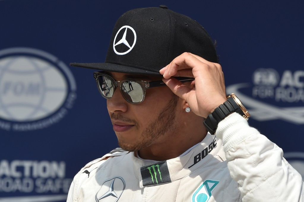 Mercedes AMG Petronas F1 Team's British driver Lewis Hamilton reacts after the qualifying race at the Hungaroring racetrack in Mogyorod, Hungary,on July 25, 2015 on the eve of the Hungarian Formula One Grand Prix . Defending world champion and series leader Lewis Hamilton bidding for a record fifth Hungarian Grand Prix victory will start from pole for Sunday's race after posting the fastest time in qualifying on Saturday. AFP PHOTO / ANDREJ ISAKOVIC