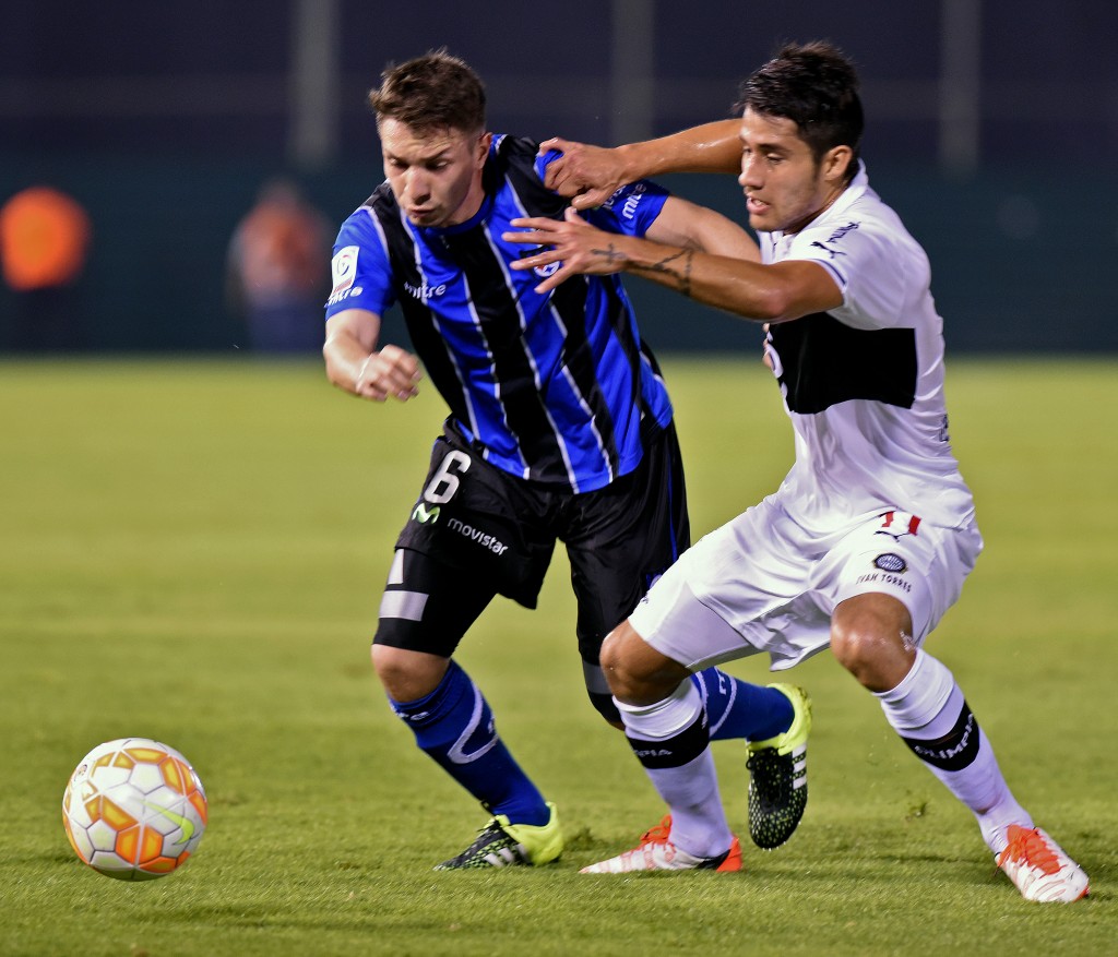Chilean Huachipato's player Claudio Sepulveda (L) vies for the ball with Paraguayan Olimpia's  Ivan Torres during their Copa Sudamericana football match at the Defensores del Chaco Stadium, in Asuncion, Paraguay on August 12, 2015. AFP PHOTO/ Norberto Duarte