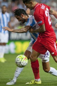 Malaga's Argentinian defender Marcos Alberto Angeleri (L) vies with Sevilla's midfielder Vitolo during the Spanish league football match Malaga CF vs Sevilla FC at La Rosaleda stadium in Malaga on August 21, 2015. AFP PHOTO / JORGE GUERRERO