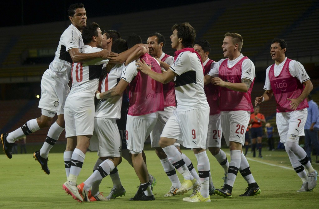 Players of Paraguay's Olimpia celebrate after teammate Jose Ariel Nunez scored against Colombia's Aguilas Doradas during their Sudamericana Cup football match at the Atanasio Girardot stadium in Medellin, Antioquia department, Colombia, on September 15, 2015. AFP PHOTO / RAUL ARBOLEDA