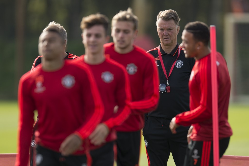 Manchester United's Dutch manager Louis van Gaal (2nd R) takes a team training session at their Carrington training complex in Manchester, north west England on September 29, 2015, ahead of their UEFA Champions League, Group B football match against VfL Wolfsburg. AFP PHOTO / OLI SCARFF