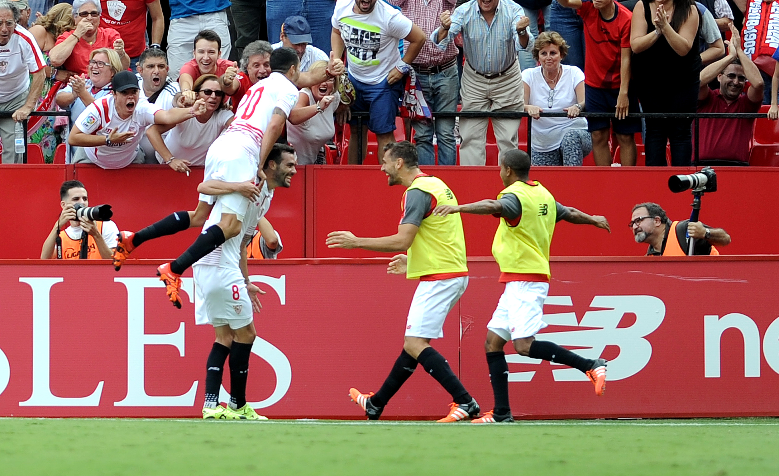 Sevilla's midfielder Iborra (L) celebrates after scoring during the Spanish league football match Sevilla FC vs Barcelona at the Ramon Sanchez Pizjuan stadium in Sevilla on October 3, 2015. AFP PHOTO/ CRISTINA QUICLER