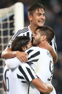 Juventus' midfielder Sami Khedira (L) from Germany celebrates with teammates Juventus' forward Paulo Dybala from Argentina (top) and Juventus' forward Alvaro Morata from Spain after scoring during the Italian Serie A football match Juventus Vs Bologna on October 4, 2015 at the "Juventus Stadium" in Turin. AFP PHOTO / MARCO BERTORELLO