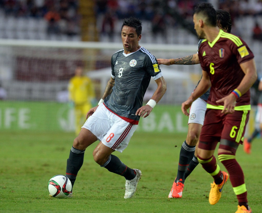 Paraguay's Lucas Barrios (L) vies for ball with Venezuela's Gabriel Cichero, during a qualifying football match for the 2018 FIFA World Cup between Venezuela and Paraguay at the Cachamay stadium, in Puerto Ordaz, Venezuela, on October 8, 2015. AFP PHOTO/FEDERICO PARRA