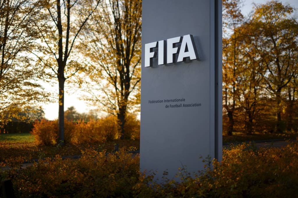 The FIFA sign is seen at the entrance of world football's governing body headquarters in Zurich on October 20, 2015. FIFA's reform committee on October 20 issued an interim report calling for "significant changes" to its structure and operations in order to restore the reputation of world football's governing body.  AFP PHOTO / FABRICE COFFRINI