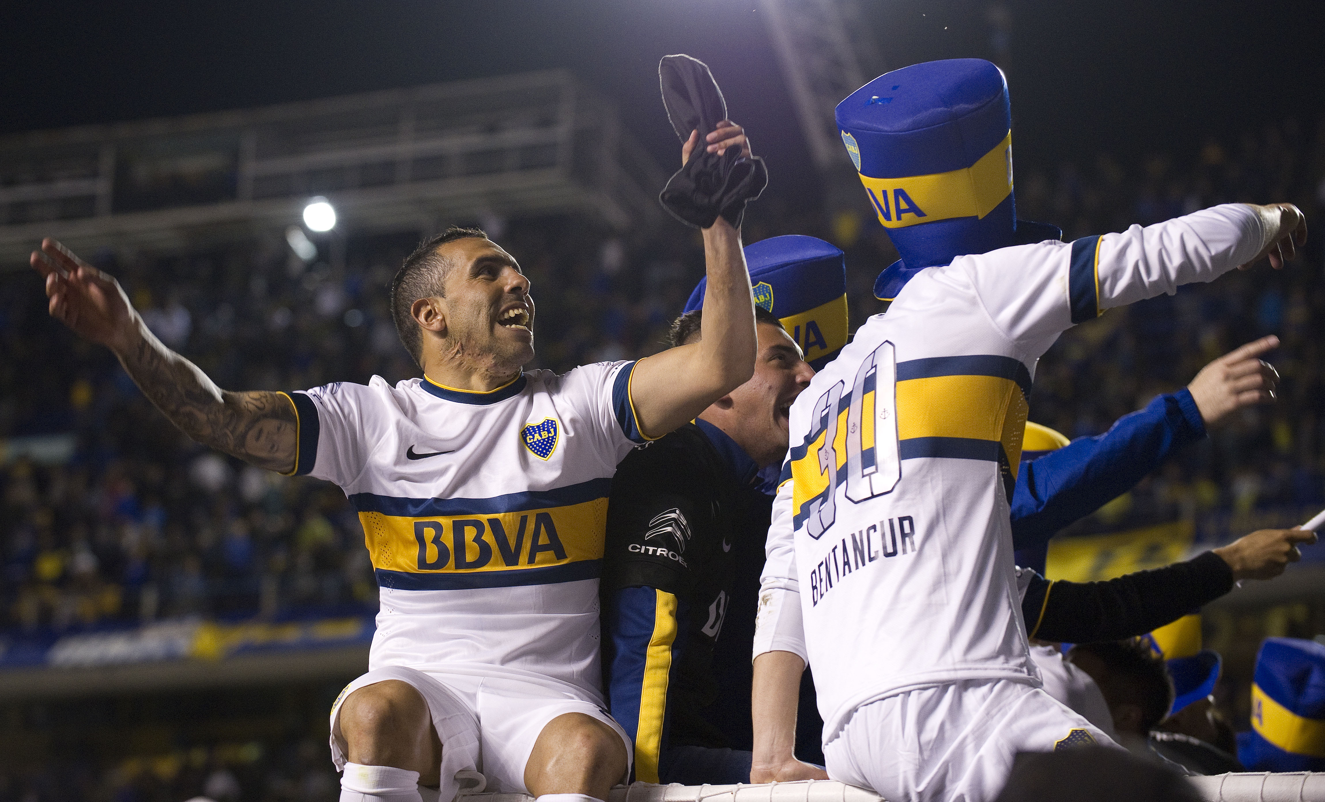Boca Juniors' forward Carlos Tevez (L) celebrates after winning Argentina's first division football championship at the "La Bombonera" stadium in Buenos Aires, on November 1, 2015. AFP PHOTO / ALEJANDRO PAGNI