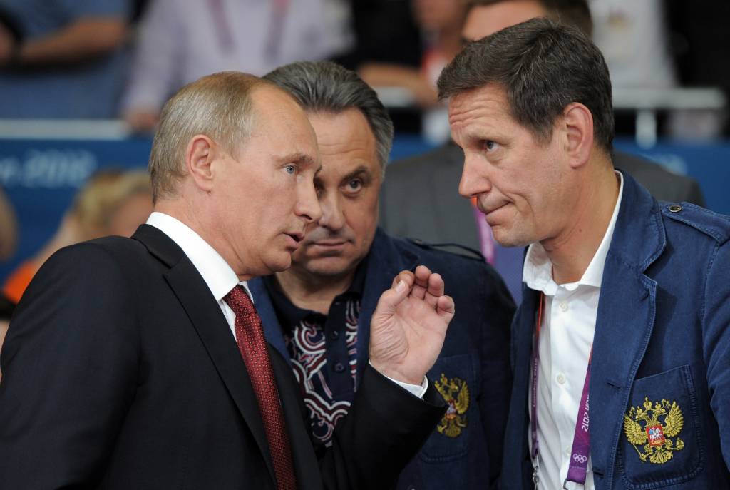 Russos correm para garantir participação nas Olimpíadas de 2016. Na foto, o presidente Vladimir Putin conversa com Ministro do Esporte da Rússia, Vitaly Mutko, e presidente do ROC Alexander Zhukov. (Foto: RIA-NOVOSTI/ ALEXEY DRUZHININ/AFP)