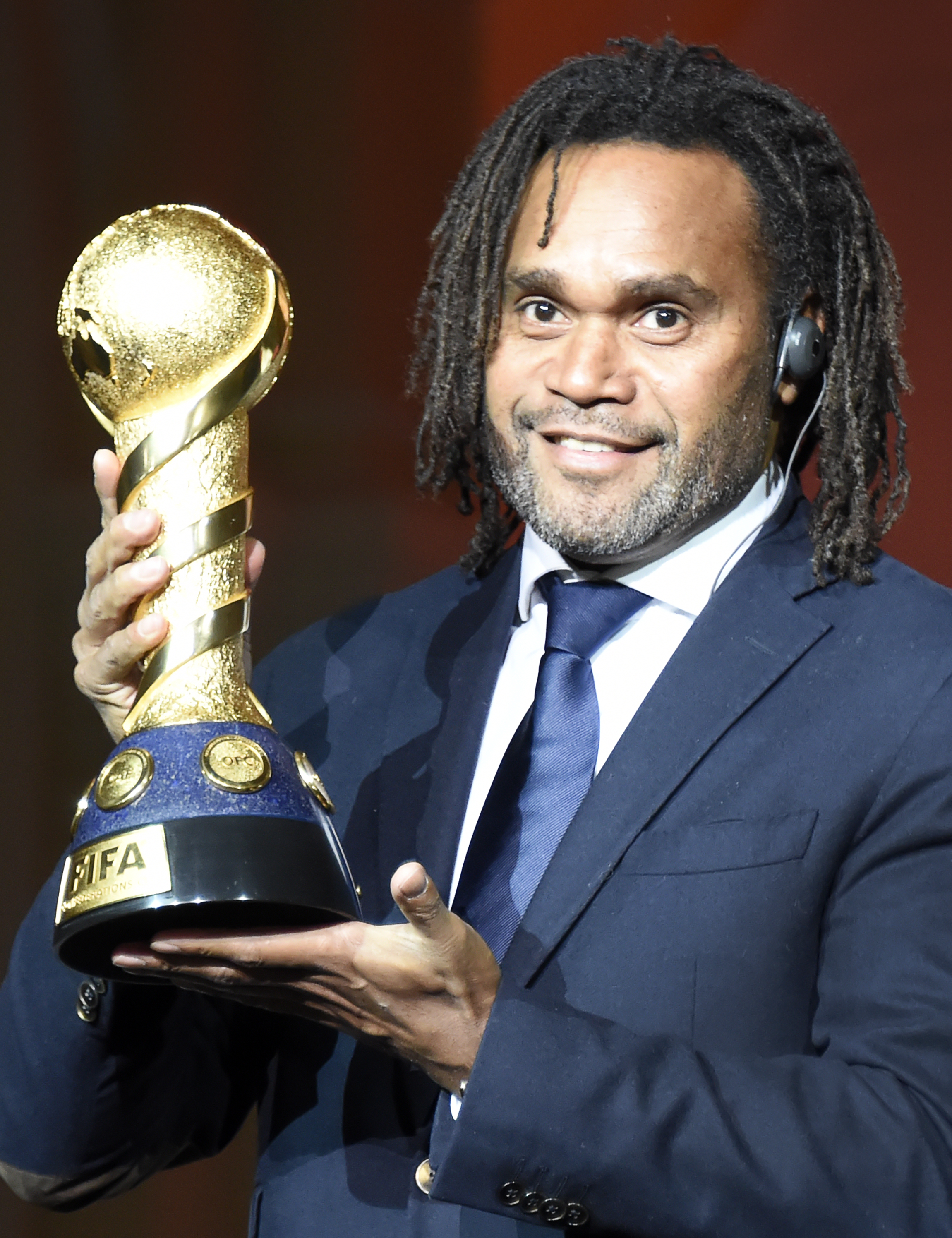 Ex-jogador Christian Karembeu demonstra a taça do torneio (Foto: ALEXANDER NEMENOV/AFP)