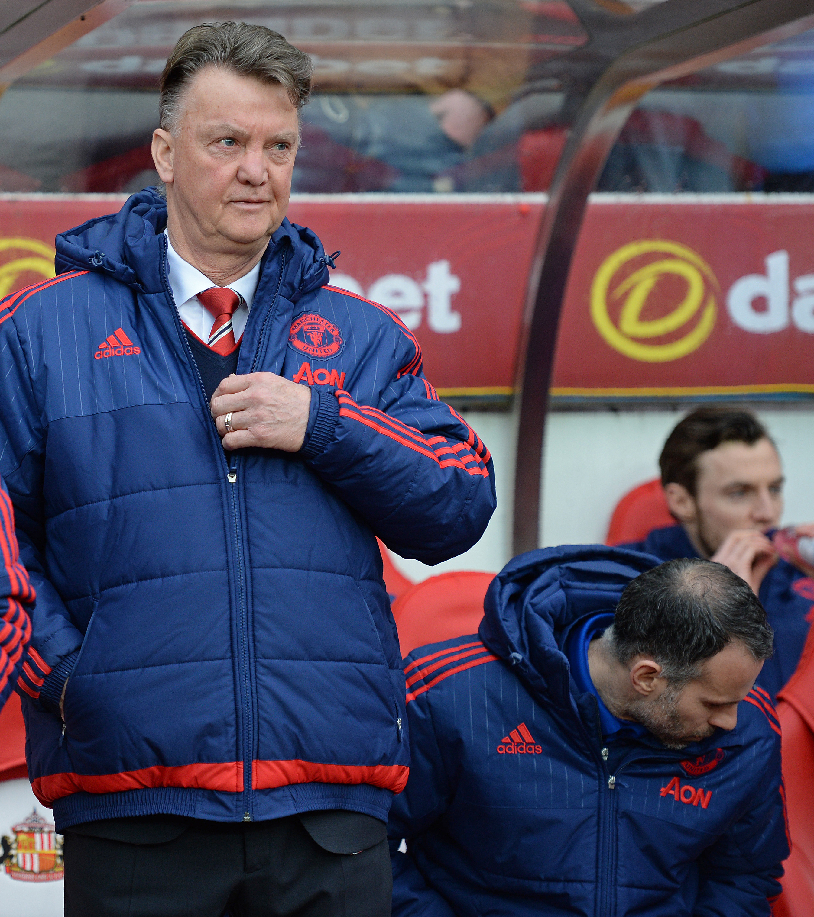 Manchester United's Dutch manager Louis van Gaal (L) and Manchester United's Welsh assistant manager Ryan Giggs take their seats in the dug out ahead of the English Premier League football match between Sunderland and Manchester United at the Stadium of Light in Sunderland, northeast England on February 13, 2016. / AFP / OLI SCARFF / RESTRICTED TO EDITORIAL USE. No use with unauthorized audio, video, data, fixture lists, club/league logos or 'live' services. Online in-match use limited to 75 images, no video emulation. No use in betting, games or single club/league/player publications.  /