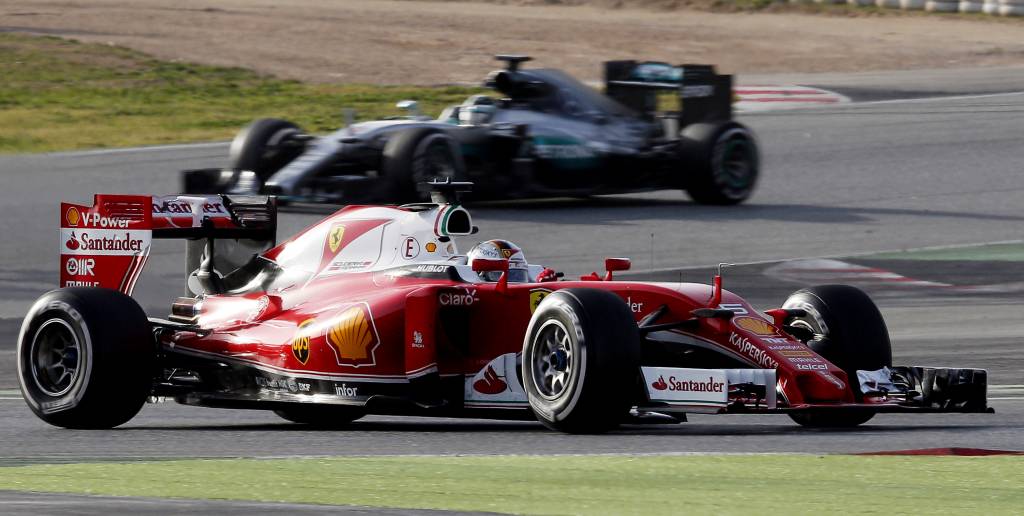 Ferrari's German driver Sebastian Vettel drives ahead of Mercedes AMG Petronas F1 Team's German driver Nico Rosberg at the Circuit de Catalunya on February 23, 2016 in Montmelo on the outskirts of Barcelona on the second test day of the Formula One Grand Prix season. / AFP / JOSE JORDAN