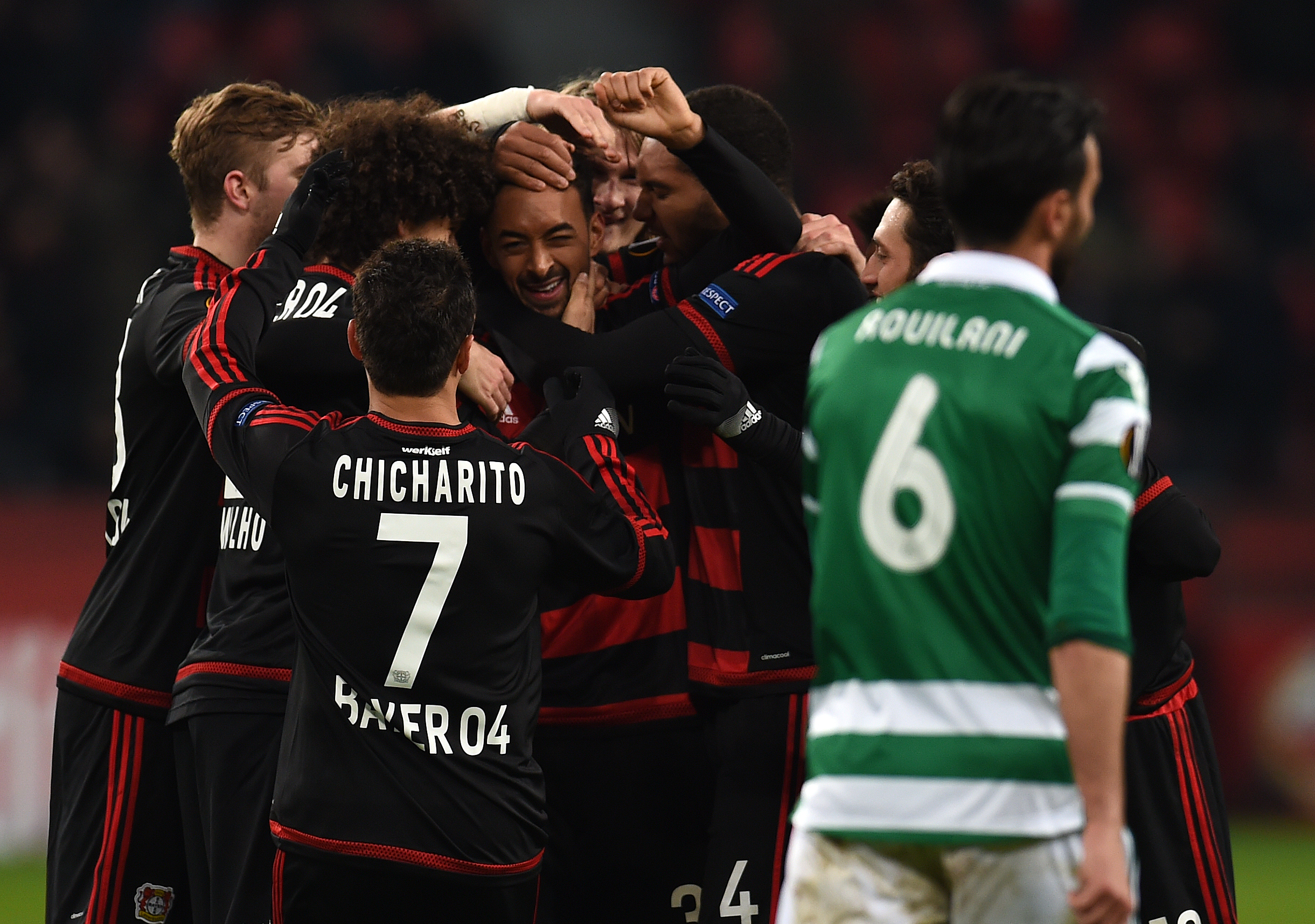 Leverkusen's midfielder Karim Bellarabi (C) and his teammates celebrate scoring during the UEFA Europa League, Round of 32 match football between Bayer Leverkusen and Sporting Lisbon in Leverkusen, western Germany on February 25, 2016. / AFP / PATRIK STOLLARZ