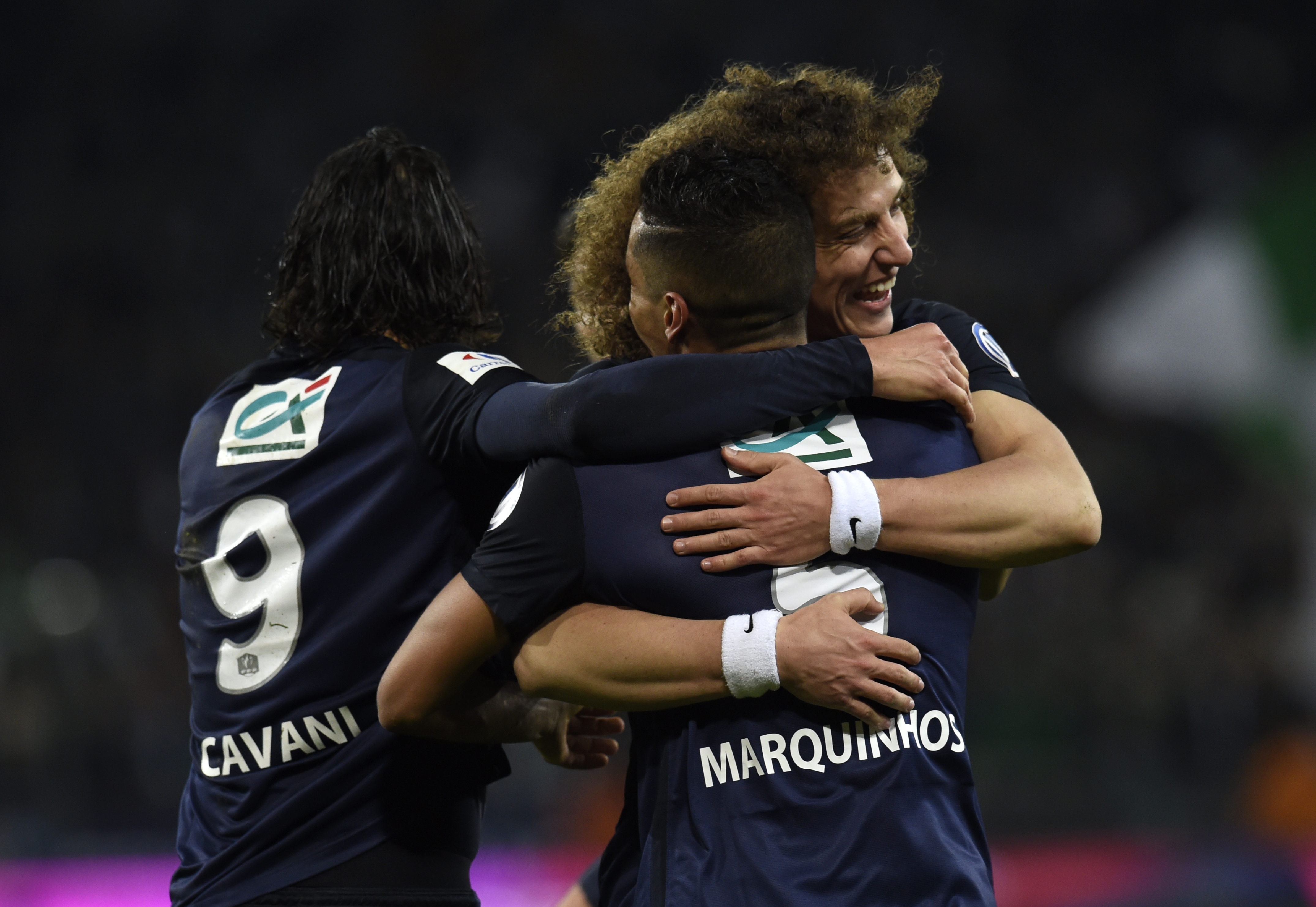 Paris Saint-Germain's Brazilian defender Marquinhos (C) celebrates with Paris Saint-Germain's Uruguayan forward Edinson Cavani (L) and Paris Saint-Germain's Brazilian defender David Luiz (R) after scoring a goal during the French Cup quarter final football match between Saint-Etienne and Paris Saint-Germain, on March 2, 2016 at the Geoffroy Guichard stadium in Saint-Etienne, central France. AFP PHOTO / PHILIPPE DESMAZES / AFP / PHILIPPE DESMAZES
