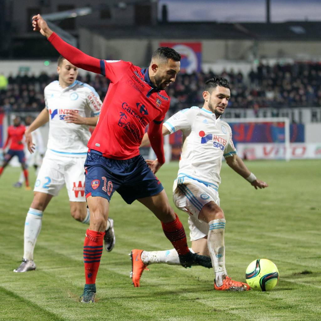 Marseille's French midfielder Remy Cabella (R) vies with Ajaccio's Tunisian midfielder Mohamed Larbi  during the L1 football match between Gazelec Ajaccio (GFCA) and L'Olympique de Marseille (OM) on March 9, 2016, at the Ange Casanova stadium in Ajaccio, on the French Mediterranean island of Corsica. AFP PHOTO / PASCAL POCHARD-CASABIANCA / AFP / PASCAL POCHARD CASABIANCA