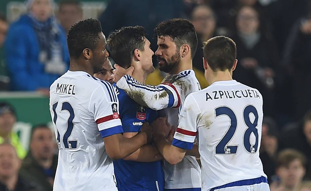 Chelsea's Brazilian-born Spanish striker Diego Costa (2nd R) and Everton's English midfielder Gareth Barry clash in the incident leading to Costa's second yellow card during the English FA cup quarter-final football match between Everton and Chelsea at Goodison Park in Liverpool, north west England on March 12, 2016. / AFP / Paul ELLIS / RESTRICTED TO EDITORIAL USE. No use with unauthorized audio, video, data, fixture lists, club/league logos or 'live' services. Online in-match use limited to 75 images, no video emulation. No use in betting, games or single club/league/player publications. /