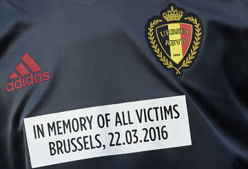 A Belgian player sports a sticker on his jersey to pay tribute to Brussels attacks victims, as he warms up before the friendly football match Portugal vs Belgium in preparation for the upcoming EURO 2016 at Magalhaes Pessoa stadium in Leiria, central Portugal, on March 29, 2016. / AFP / FRANCISCO LEONG
