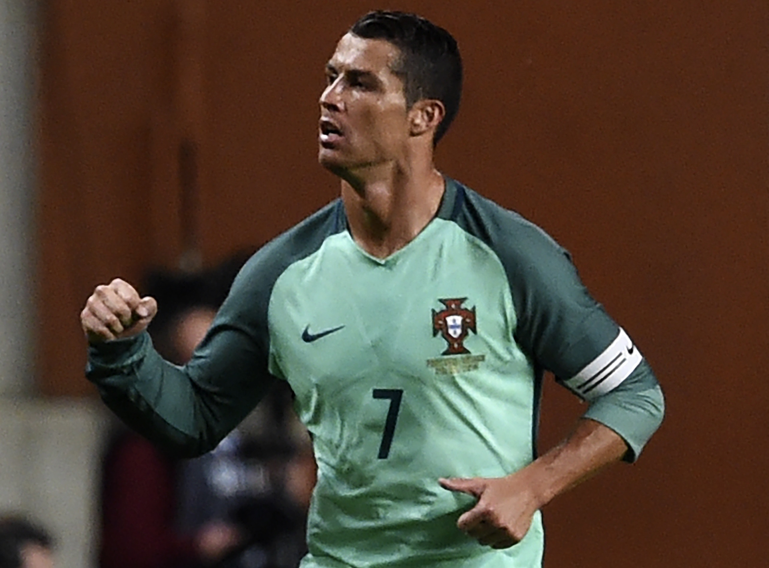 Portugal's forward Cristiano Ronaldo celebrates a goal during the friendly football match between Portugal and Belgium at Magalhaes Pessoa stadium in Leiria, Portugal on March 29, 2016. / AFP / FRANCISCO LEONG