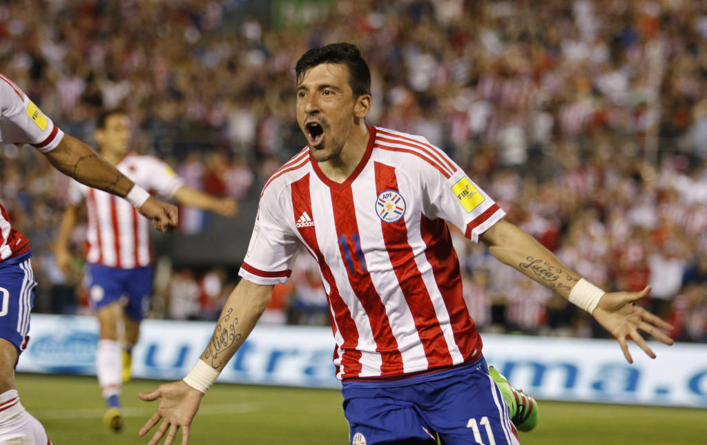 Paraguay's Edgar Benitez celebrates after scoring against Brazil during their Russia 2018 FIFA World Cup South American Qualifiers' football match in Asuncion, on March 29, 2016. AFP PHOTO / NORBERTO DUARTE / AFP / NORBERTO DUARTE