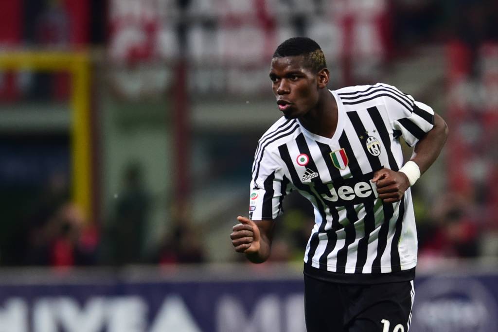 Juventus' midfielder from France Paul Pogba celebrates after scoring a goal during the Italian Serie A football match AC Milan' vs Juventus at "San Siro" Stadium in Milan on April 9, 2016. / AFP PHOTO / GIUSEPPE CACACE