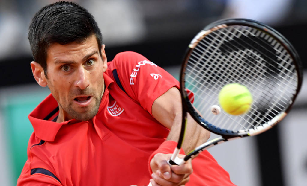 Serbia's Novak Djokovic returns the ball to Brazil's Tomaz Bellucci during their match at the ATP Tennis Open tournament at the Foro Italico, on May 12, 2016 in Rome. / AFP PHOTO / TIZIANA FABI