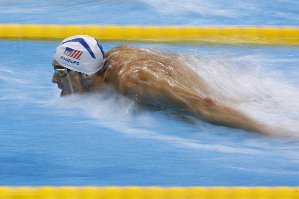 USA's Michael Phelps competes in a Men's 100m Butterfly heat during the swimming event at the Rio 2016 Olympic Games at the Olympic Aquatics Stadium in Rio de Janeiro on August 11, 2016. / AFP PHOTO / Odd Andersen