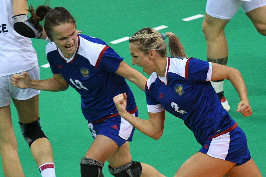 Russia's left wing Polina Kuznetsova (R) celebrates a goal with Russia's right wing Anna Vyakhireva during the women's Gold Medal handball match France vs Russia for the Rio 2016 Olympics Games at the Future Arena in Rio on August 20, 2016. / AFP PHOTO / Roberto SCHMIDT