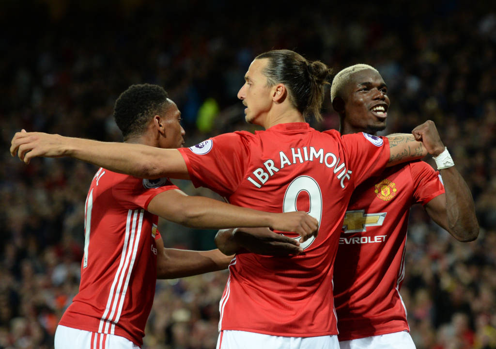 Manchester United's Swedish striker Zlatan Ibrahimovic (C) celebrates with Manchester United's French midfielder Paul Pogba (R) and Manchester United's French striker Anthony Martial after scoring their second goal from the penalty spot during the English Premier League football match between Manchester United and Southampton at Old Trafford in Manchester, north west England, on August 19, 2016. / AFP PHOTO / Oli SCARFF / RESTRICTED TO EDITORIAL USE. No use with unauthorized audio, video, data, fixture lists, club/league logos or 'live' services. Online in-match use limited to 75 images, no video emulation. No use in betting, games or single club/league/player publications.  /