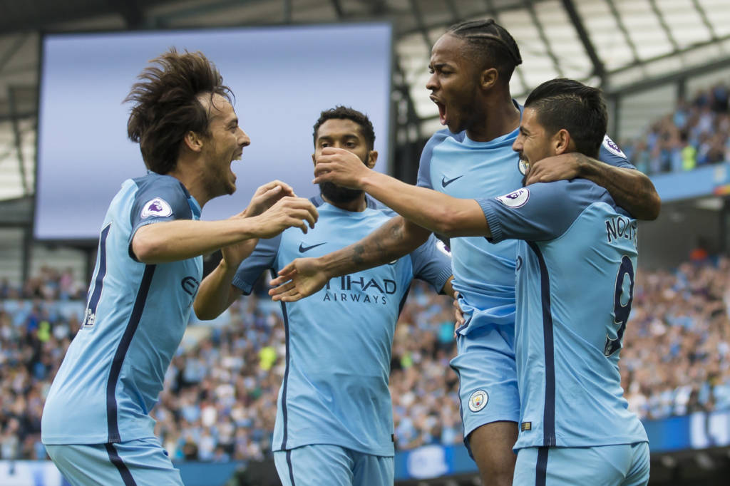 Manchester City's English midfielder Raheem Sterling (2nd R) celebrates with Manchester City's Spanish midfielder David Silva (L), Manchester City's French defender Gael Clichy and Manchester City's Spanish midfielder Nolito (R) after scoring their opening goal during the English Premier League football match between Manchester City and West Ham United at the Etihad Stadium in Manchester, north west England, on August 28, 2016. / AFP PHOTO / JON SUPER / RESTRICTED TO EDITORIAL USE. No use with unauthorized audio, video, data, fixture lists, club/league logos or 'live' services. Online in-match use limited to 75 images, no video emulation. No use in betting, games or single club/league/player publications. /