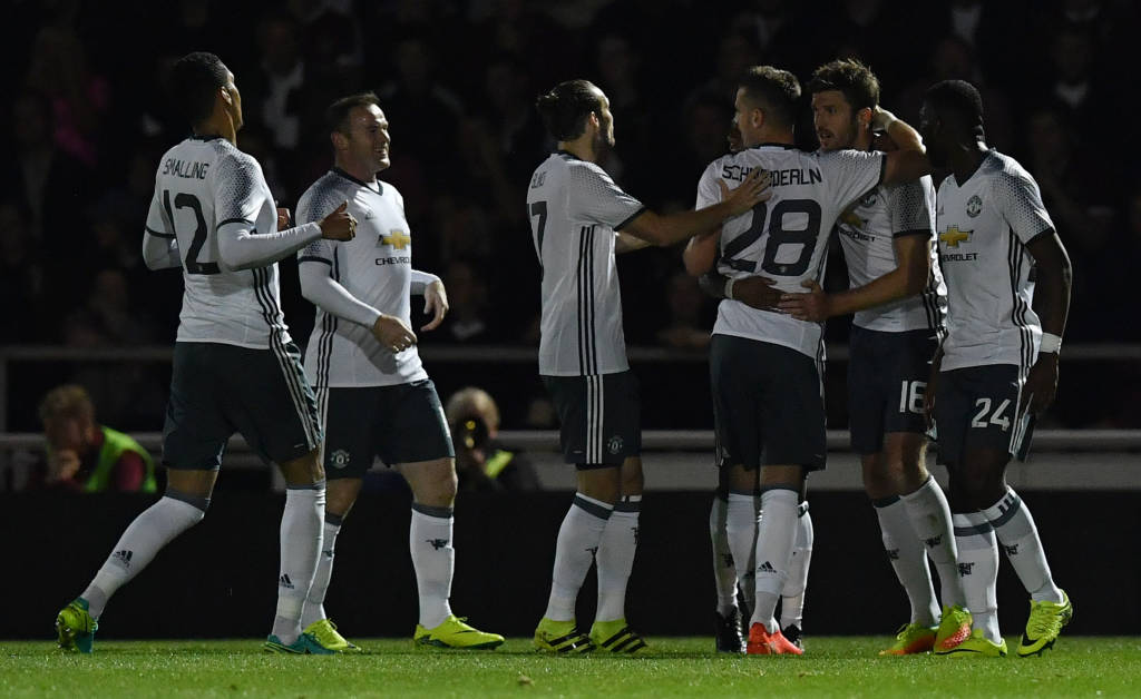Manchester United's English midfielder Michael Carrick (2R) celebrates scoring his team's first goal during the English League Cup third round football match between Northampton Town and Manchester United at the Sixfields Stadium in Northampton, central England, on September 21, 2016. / AFP PHOTO / Ben STANSALL / RESTRICTED TO EDITORIAL USE. No use with unauthorized audio, video, data, fixture lists, club/league logos or 'live' services. Online in-match use limited to 75 images, no video emulation. No use in betting, games or single club/league/player publications.  /