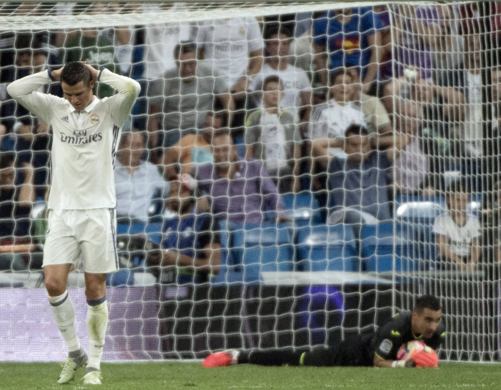 Real Madrid's Portuguese forward Cristiano Ronaldo gestures after missing a goal during the Spanish league football match Real Madrid CF vs Villarreal CF at the Santiago Bernabeu stadium in Madrid on September 21, 2016. / AFP PHOTO / CURTO DE LA TORRE