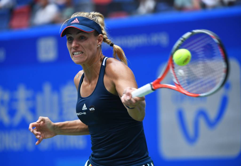 Angelique Kerber of Germany hits a return during her second round match against Kristina Mladenovic of France at the WTA Wuhan Open in Wuhan, in China's central Hubei province on September 27, 2016. / AFP PHOTO / GREG BAKER