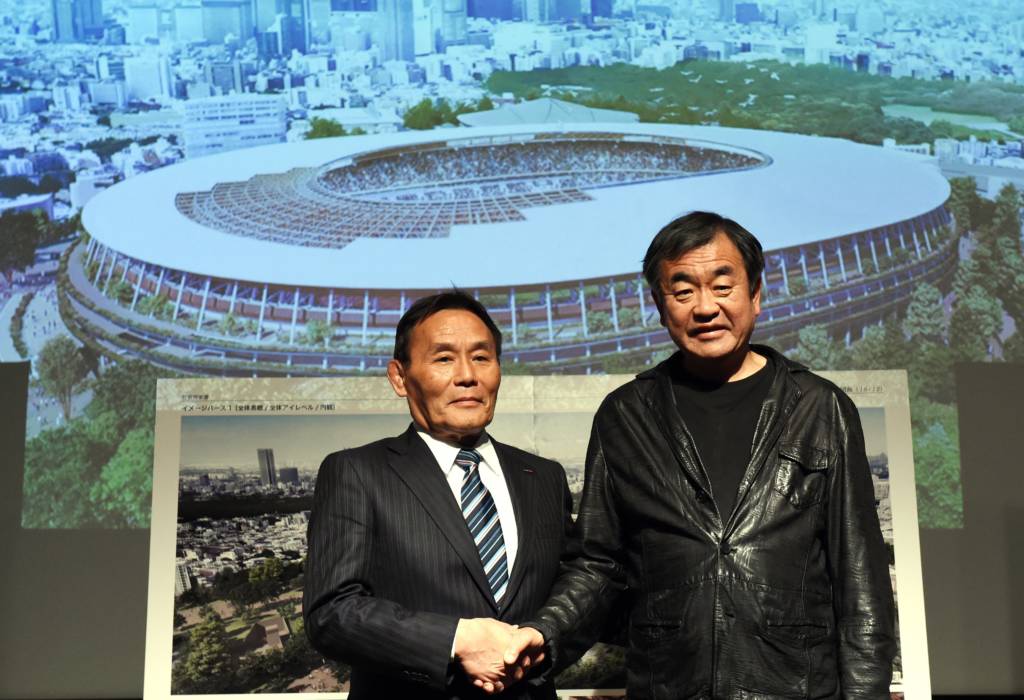 (FILES) This file picture taken on December 22, 2015 shows Japan Sports Council (JSC) president Kazumi Ohigashi (L) shaking hands with architect Kengo Kuma (R) during a press conference announcing the new design of the national stadium in Tokyo. The Japanese government on September 30, 2016 approved plans for the building of the main stadium for the Tokyo 2020 Olympics at a cost of almost $1.5 billion USD. / AFP PHOTO / TOSHIFUMI KITAMURA