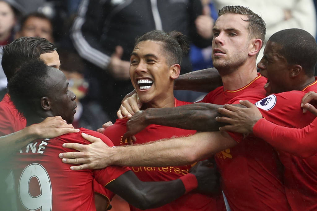 Liverpool's Brazilian midfielder Roberto Firmino (C) celebrates scoring their first goal to equalise 1-1 during the English Premier League football match between Swansea City and Liverpool at The Liberty Stadium in Swansea, south Wales on October 1, 2016. / AFP PHOTO / Geoff CADDICK / RESTRICTED TO EDITORIAL USE. No use with unauthorized audio, video, data, fixture lists, club/league logos or 'live' services. Online in-match use limited to 75 images, no video emulation. No use in betting, games or single club/league/player publications. /