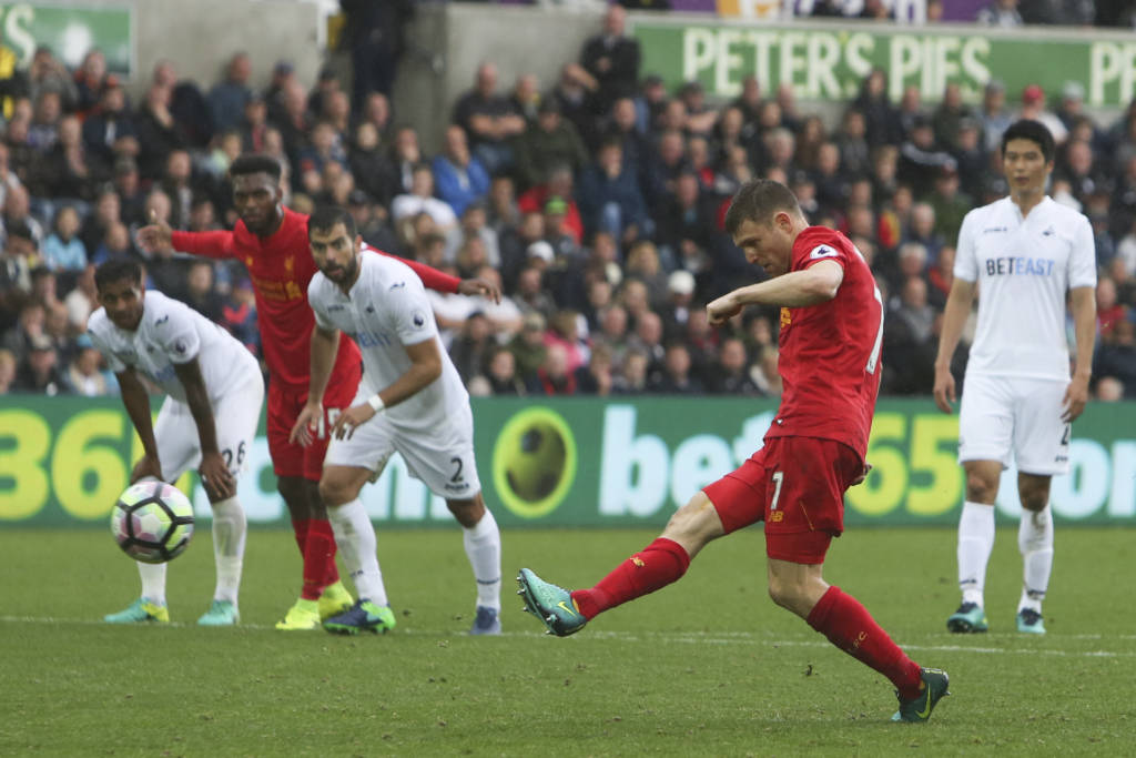 Liverpool's English midfielder James Milner (2R) scores their second goal from the penalty spot to take the lead 1-2 during the English Premier League football match between Swansea City and Liverpool at The Liberty Stadium in Swansea, south Wales on October 1, 2016. / AFP PHOTO / Geoff CADDICK / RESTRICTED TO EDITORIAL USE. No use with unauthorized audio, video, data, fixture lists, club/league logos or 'live' services. Online in-match use limited to 75 images, no video emulation. No use in betting, games or single club/league/player publications. /