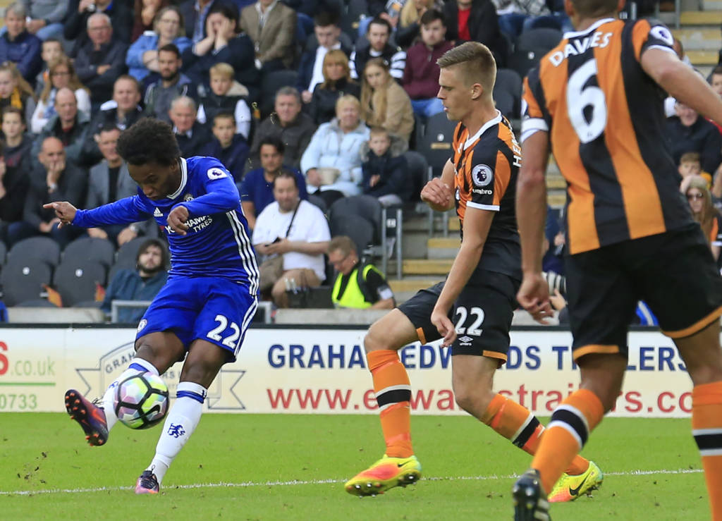Chelsea's Brazilian midfielder Willian (L) shoots to score the opening goal of the English Premier League football match between Hull City and Chelsea at the KCOM Stadium in Kingston upon Hull, north east England on October 1, 2016. / AFP PHOTO / Lindsey PARNABY / RESTRICTED TO EDITORIAL USE. No use with unauthorized audio, video, data, fixture lists, club/league logos or 'live' services. Online in-match use limited to 75 images, no video emulation. No use in betting, games or single club/league/player publications.  /