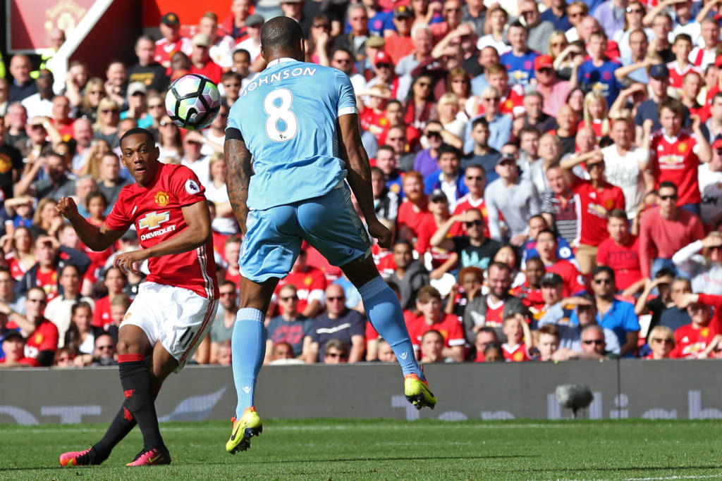 Manchester United's French striker Anthony Martial (L) shoots to score the opening goal past Stoke City's English defender Glen Johnson during the English Premier League football match between Manchester United and Stoke City at Old Trafford in Manchester, north west England, on October 2, 2016. / AFP PHOTO / Scott Heppell / RESTRICTED TO EDITORIAL USE. No use with unauthorized audio, video, data, fixture lists, club/league logos or 'live' services. Online in-match use limited to 75 images, no video emulation. No use in betting, games or single club/league/player publications. /