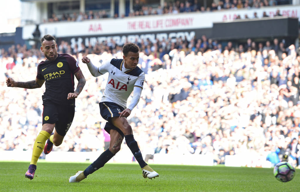 Tottenham Hotspur's English midfielder Dele Alli shoots to score their second goal under pressure from Manchester City's Argentinian defender Nicolas Otamendi (L) during the English Premier League football match between Tottenham Hotspur and Manchester City at White Hart Lane in London, on October 2, 2016. / AFP PHOTO / Glyn KIRK / RESTRICTED TO EDITORIAL USE. No use with unauthorized audio, video, data, fixture lists, club/league logos or 'live' services. Online in-match use limited to 75 images, no video emulation. No use in betting, games or single club/league/player publications. /