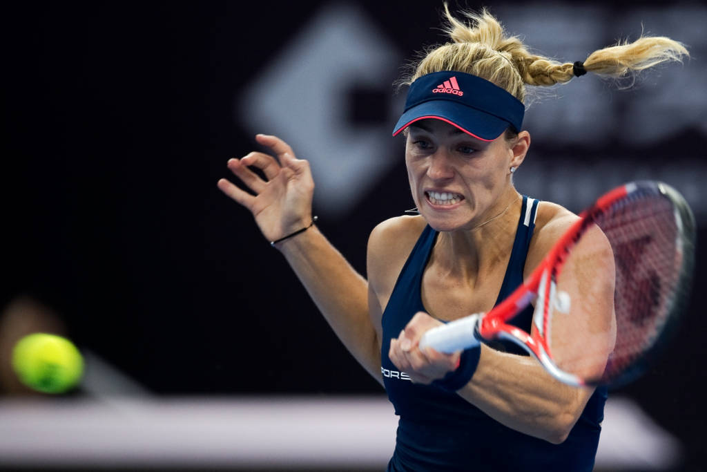 Angelique Kerber of Germany hits a return to Elina Svitolina of Ukraine during the women's singles third round of the China Open tennis tournament in Beijing on October 6, 2016. / AFP PHOTO / NICOLAS ASFOURI