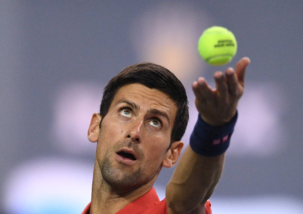 Novak Djokovic of Serbia serves against Fabio Fognini of Italy during their men's singles match at the Shanghai Masters tennis tournament in Shanghai on October 11, 2016. / AFP PHOTO / JOHANNES EISELE