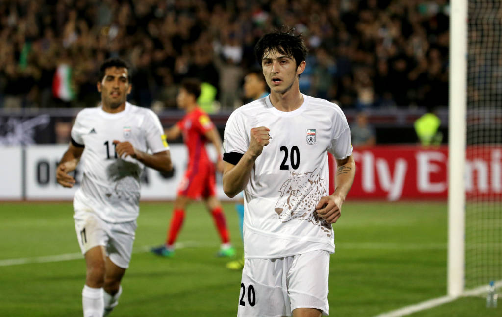 Iran's Sardar Azmoun celebrates after scoring their opening goal during the 2018 World Cup qualifying football match between Iran and South Korea at the Azadi Stadium in Tehran on October 11, 2016. / AFP PHOTO / ATTA KENARE