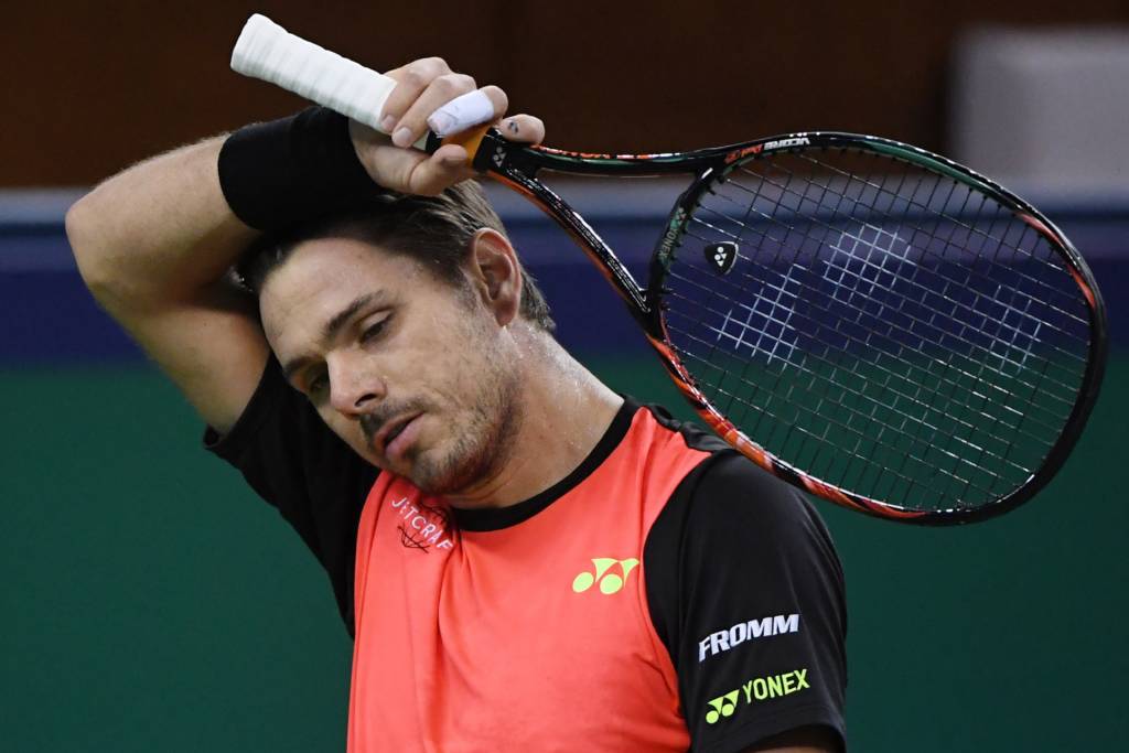 Stan Wawrinka of Switzerland reacts after losing a point against Gilles Simon of France during their men's singles match at the Shanghai Masters tennis tournament in Shanghai on October 13, 2016. / AFP PHOTO / WANG ZHAO