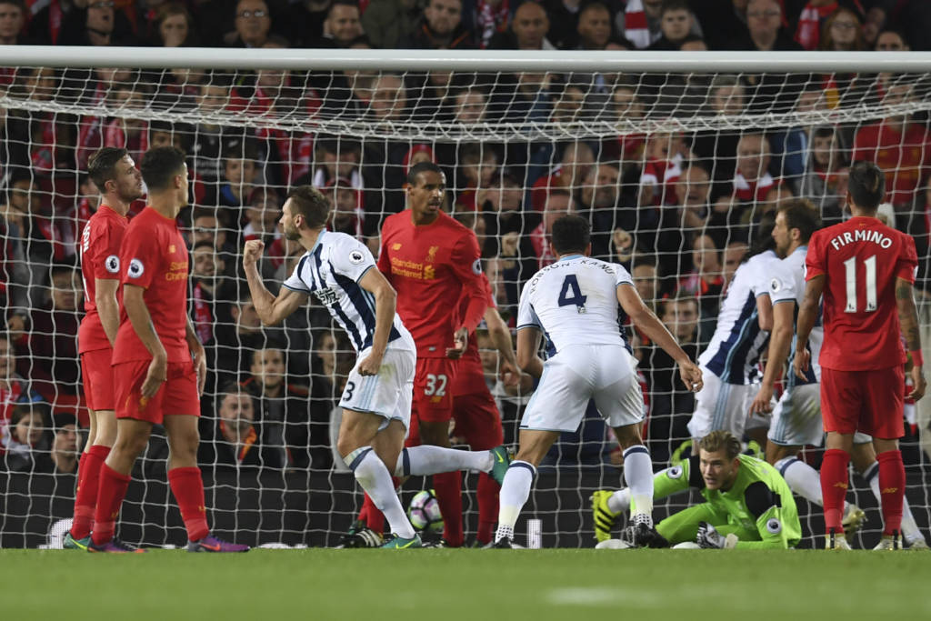 West Bromwich Albion's Northern Irish defender Gareth McAuley (3L) turns to celerbate scoring their first goal during the English Premier League football match between Liverpool and West Bromwich Albion at Anfield in Liverpool, north west England on September 10, 2016. / AFP PHOTO / PAUL ELLIS / RESTRICTED TO EDITORIAL USE. No use with unauthorized audio, video, data, fixture lists, club/league logos or 'live' services. Online in-match use limited to 75 images, no video emulation. No use in betting, games or single club/league/player publications. /