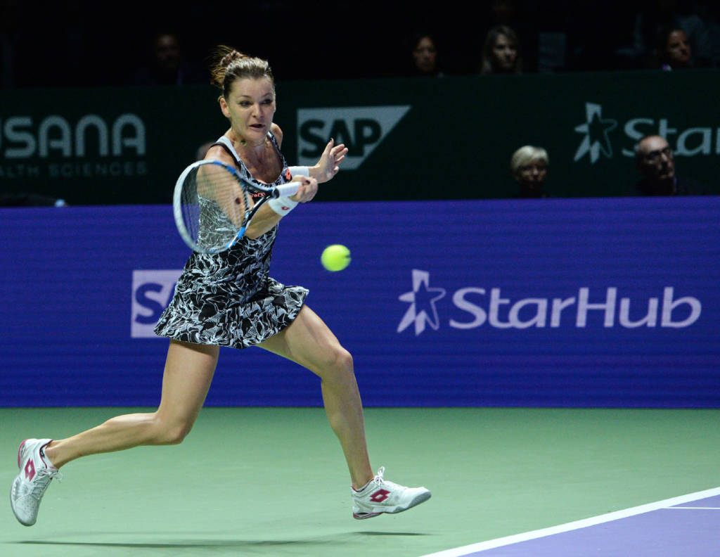 Poland 's Agnieszka Radwanska plays against Spain's Garbiñe Muguruza in their women's singles match during the WTA Finals  tennis tournament on October 26, 2016 in Singapore. / AFP PHOTO / ROSLAN RAHMAN