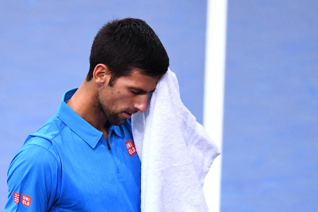 Serbia's Novak Djokovic wipes his face with a towel during his quarter-final tennis match against Croatia's Marin Cilic at the ATP World Tour Masters 1000 indoor tournament in Paris on November 4, 2016. / AFP PHOTO / FRANCK FIFE
