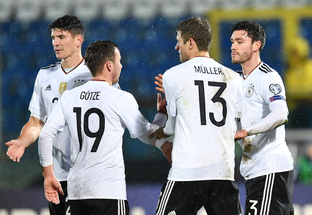 German defender Jonas Hector (R) celebrates with teammates after scoring during the World Cup 2018 qualifying soccer match San Marino vs Germany at the San Marino stadium in Serravalle on November 11, 2016. / AFP PHOTO / VINCENZO PINTO