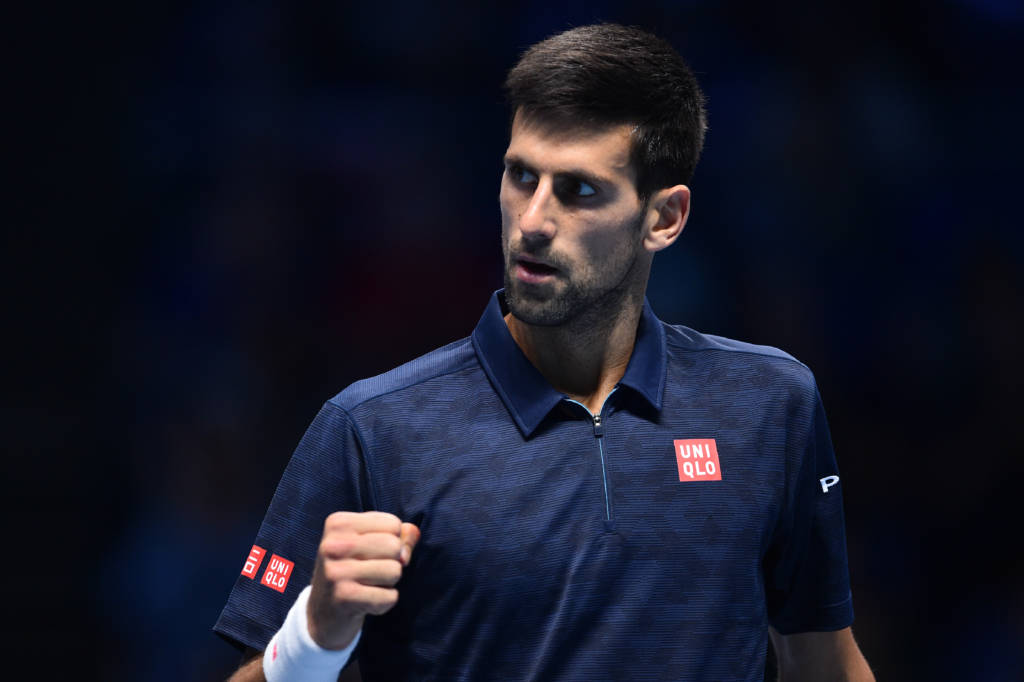 Serbia's Novak Djokovic celebrates a point against Austria's Dominic Thiem during their round robin stage men's singles match on day one of the ATP World Tour Finals tennis tournament in London on November 13, 2016. / AFP PHOTO / GLYN KIRK