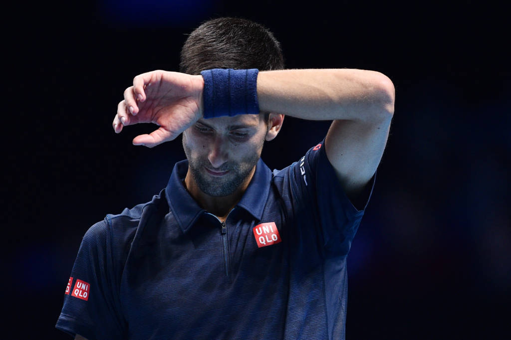 Serbia's Novak Djokovic reacts after losing a point to Austria's Dominic Thiem during their round robin stage men's singles match on day one of the ATP World Tour Finals tennis tournament in London on November 13, 2016. / AFP PHOTO / GLYN KIRK