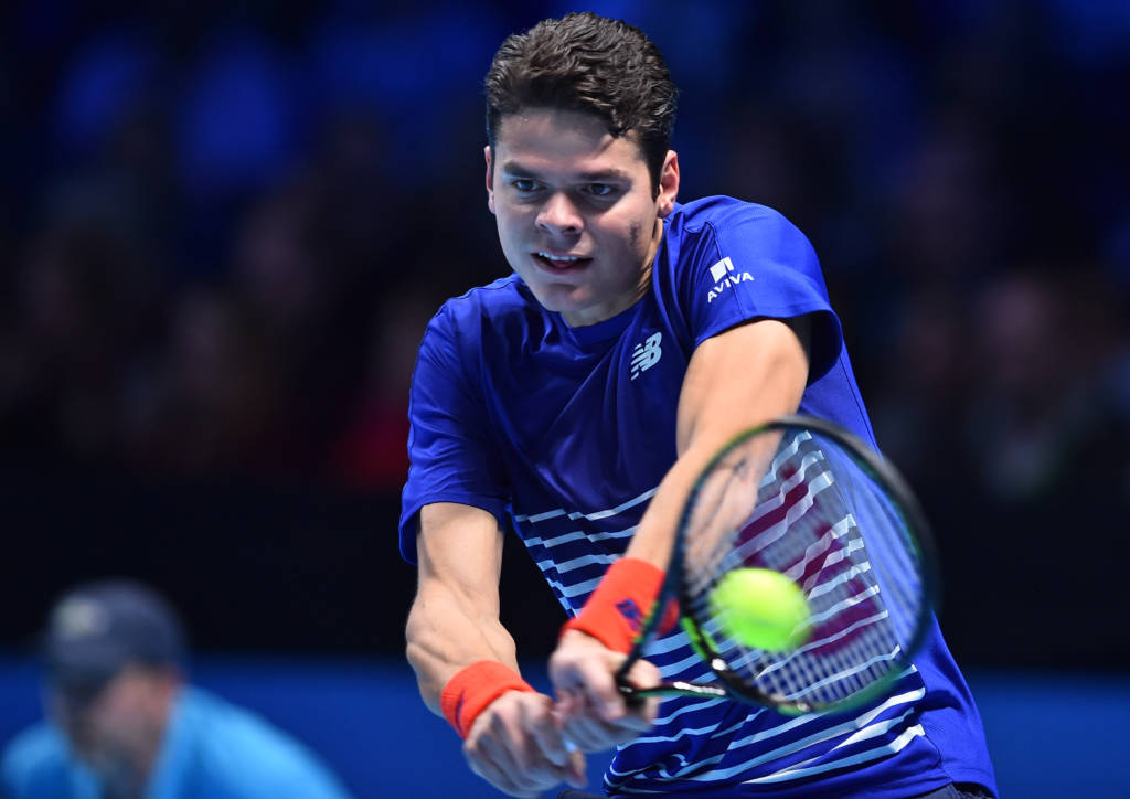 Canada's Milos Raonic returns to France's Gael Monfils during their round robin stage men's singles match on day one of the ATP World Tour Finals tennis tournament in London on November 13, 2016. / AFP PHOTO / GLYN KIRK