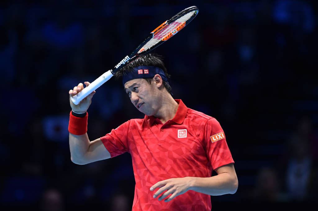 Japan's Kei Nishikori reacts against Britain's Andy Murray during their round robin stage men's singles match on day four of the ATP World Tour Finals tennis tournament in London on November 16, 2016. / AFP PHOTO / Glyn KIRK
