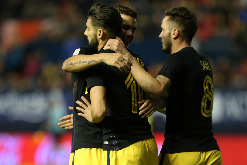 Atletico Madrid's Belgian midfielder Yannick Ferreira Carrasco (L) celebrates with teammates during the Spanish league football match CA Osasuna vs Club Atletico de Madrid at El Sadar stadium in Pamplona, on November 27, 2016. / AFP PHOTO / CESAR MANSO