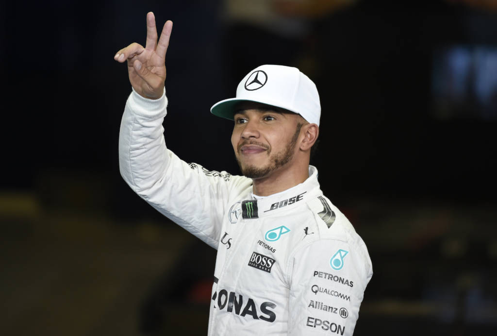 Mercedes AMG Petronas F1 Team's British driver Lewis Hamilton gestures after taking pole position in the qualifying session as part of the Abu Dhabi Formula One Grand Prix at the Yas Marina circuit on November 26, 2016. / AFP PHOTO / MOHAMMED AL-SHAIKH